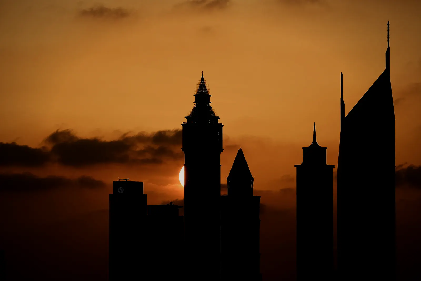Dubai skyline in silhouette at sunset