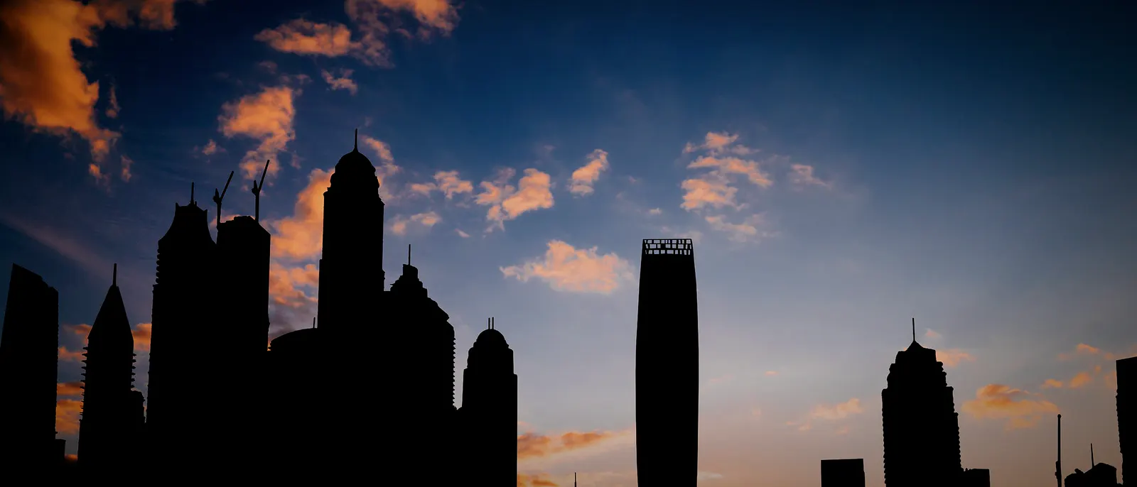 Dubai Marina towers in silhouette at sunset
