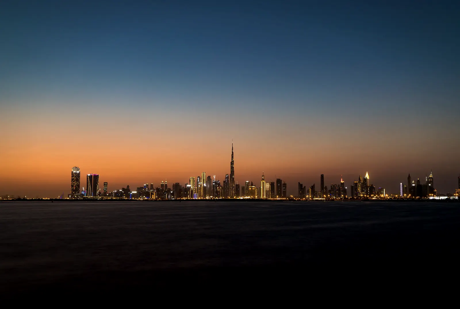 Dubai skyline across the water at dusk